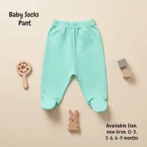 A collection of six assorted baby socks pants featuring various animal prints, stripes, and solid colors, displayed with wooden nursery toys